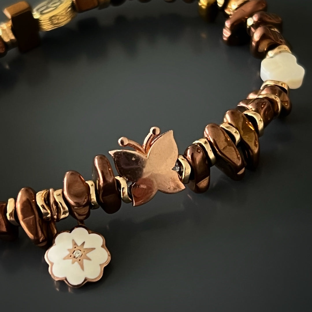 Experience the grace and beauty of the Rose Energy Spring Bracelet, featuring rose gold hematite beads and enchanting silver charms.