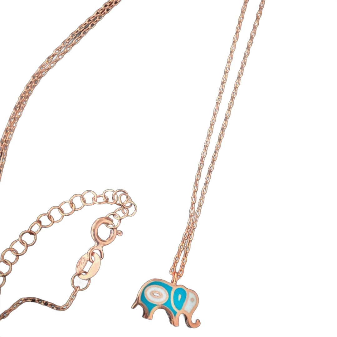 Discover the elegance of the Rose Gold Elephant Necklace, a handmade piece with a tiny elephant pendant in rose gold, representing good luck and accompanied by an evil eye bead for protection.