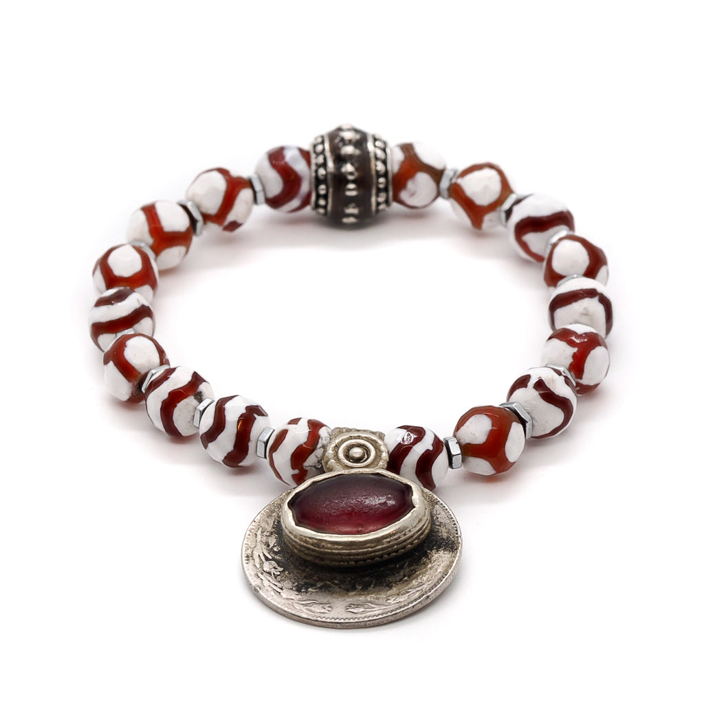Discover the captivating beauty of the Royal Abundance Bracelet, featuring mystical Tibetan agate stones in rich red and white hues.