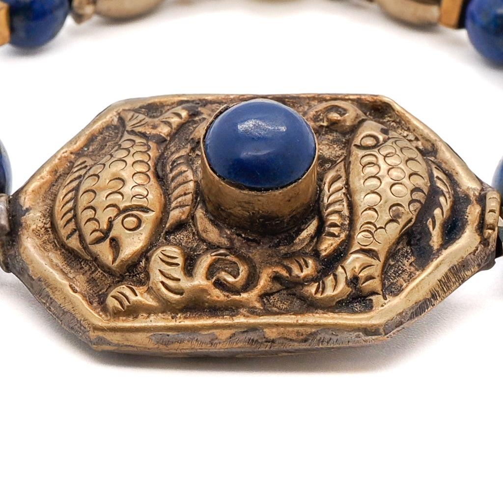 Experience the vibrant energy of the Samsara Bracelet, crafted with Lapis Lazuli stone beads and a bronze Golden Fish charm.