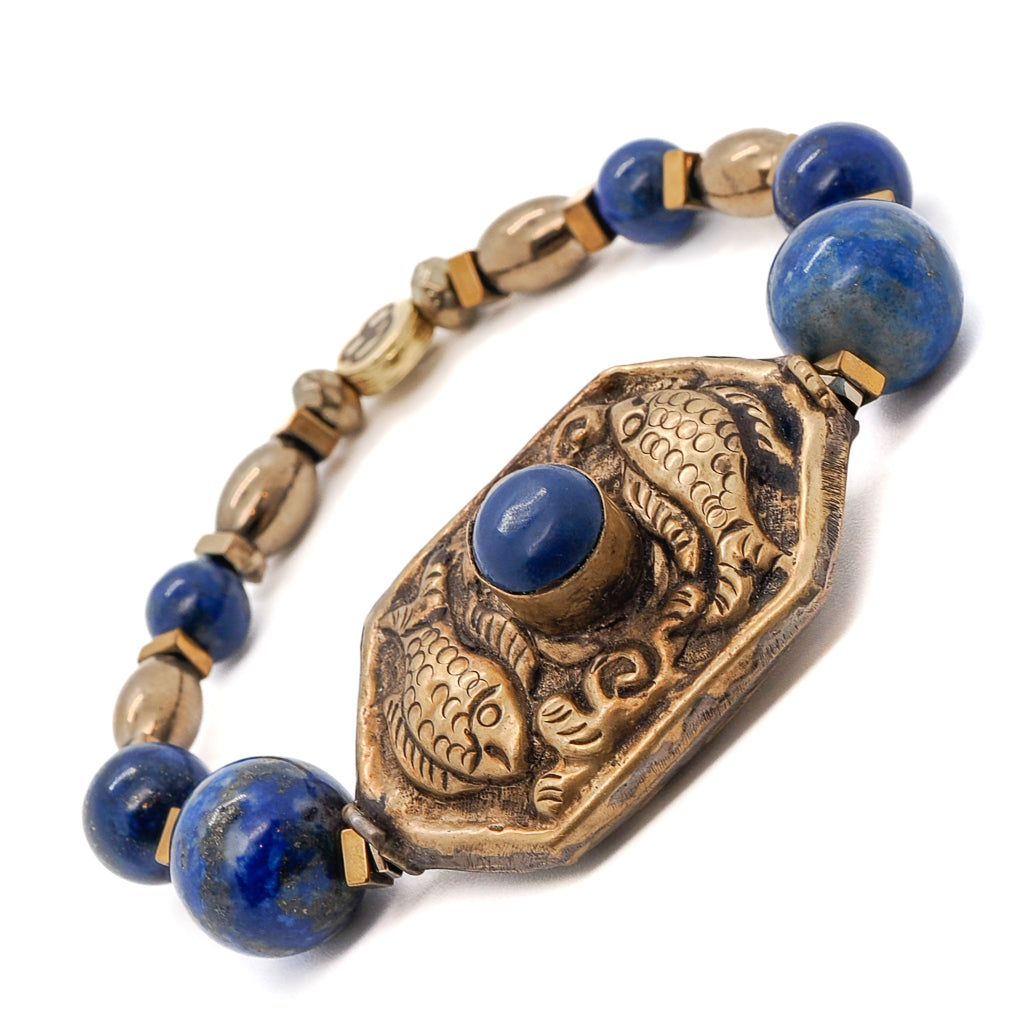 Embrace the unique symbolism of the Samsara Bracelet, combining Lapis Lazuli stone beads and a Nepal handmade Golden Fish charm.