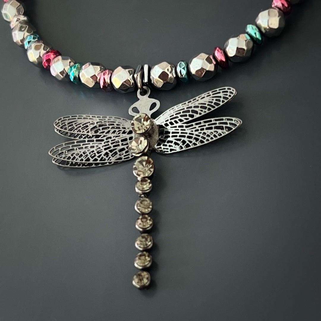 The Self Love Dragonfly Anklet is a symbol of personal growth and self-acceptance, crafted with silver hematite stone beads, blue and pink hematite spacers, and a silver dragonfly charm that embodies transformation and inner strength.