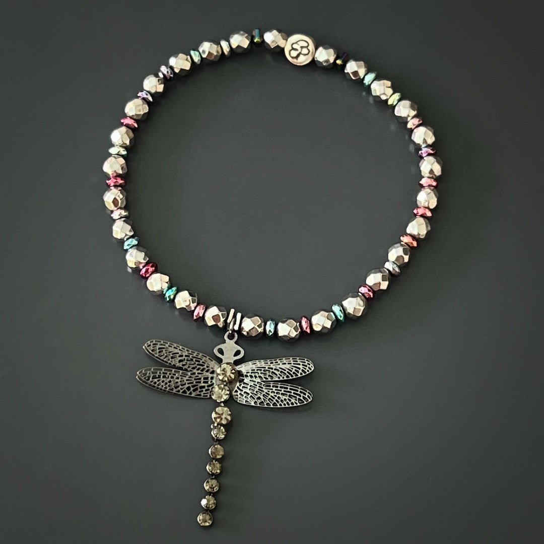 Celebrate self-love and personal growth with the exquisite Self Love Dragonfly Anklet, showcasing silver hematite stone beads, blue and pink hematite spacers, and a silver dragonfly charm that inspires resilience and adaptability.