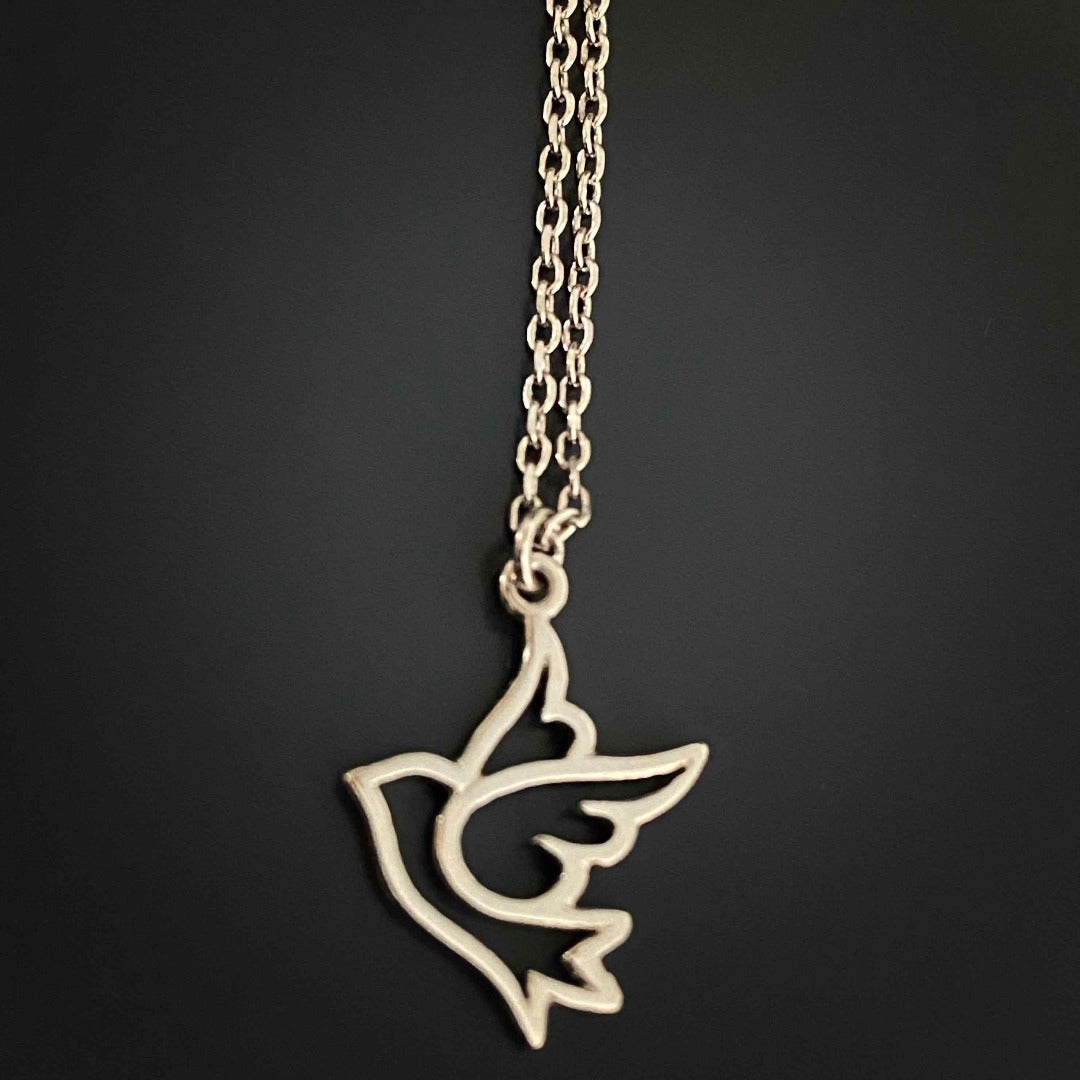 Discover the elegance of the Silver Bird Necklace, a handmade piece crafted with high quality sterling silver, showcasing a flying bird pendant that represents rebirth and peace.