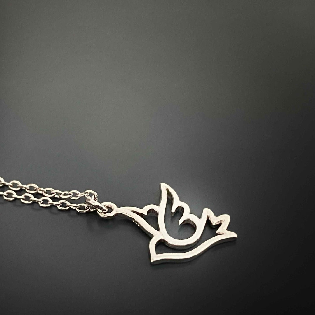 Experience the beauty of the Silver Bird Necklace, with its simple design and significant symbolism, including a flying bird pendant that embodies hope and peace.