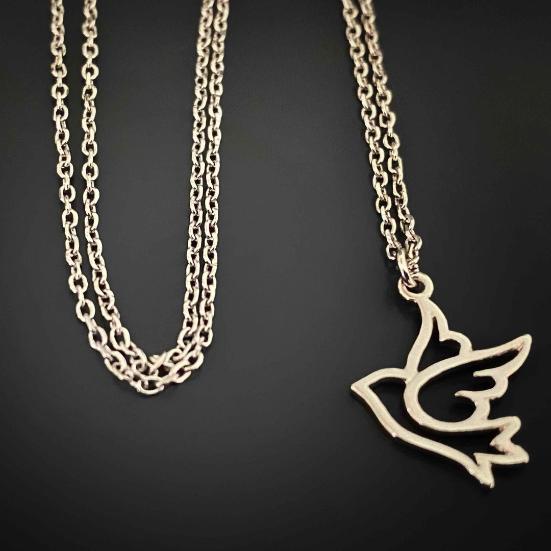 Adorn yourself with the Silver Bird Necklace, a dainty and stylish piece featuring a flying bird pendant on a sterling silver chain, representing freedom and peace.