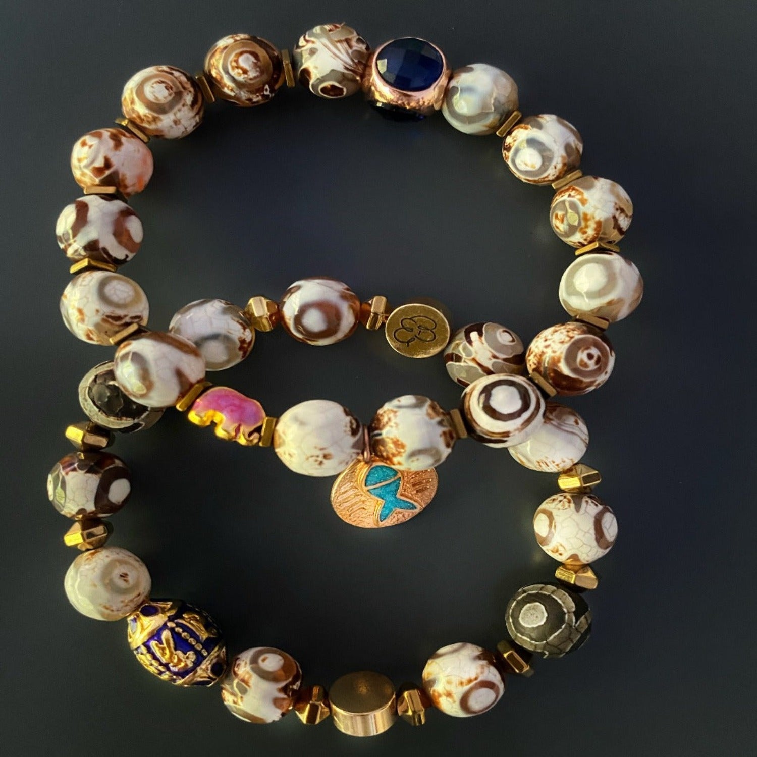 Experience the harmony and fortune of the Lucky Fish Bracelet Set, featuring Tibetan agate beads, gold hematite, and charms symbolizing good luck and prosperity.