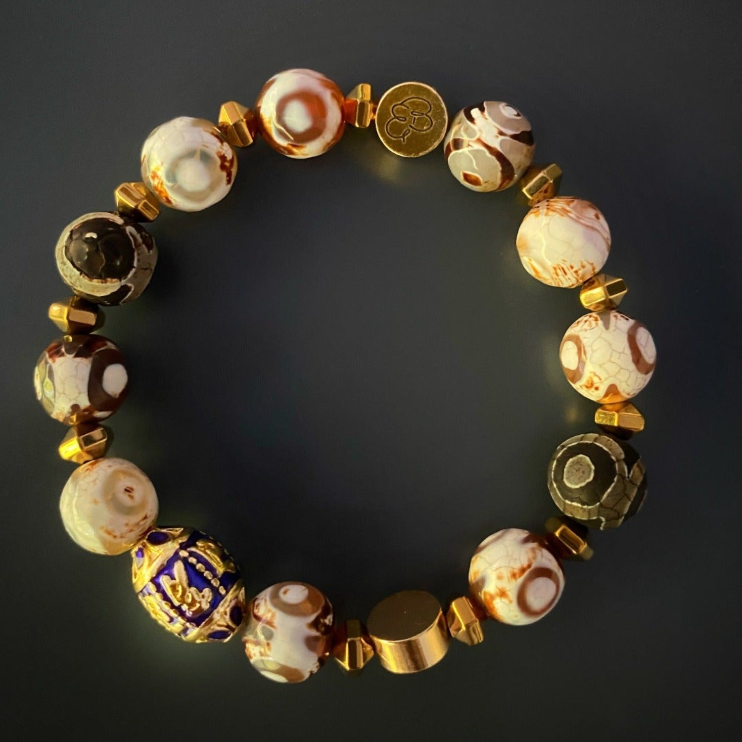 Adorn your wrist with the Lucky Fish Bracelet Set, a handmade accessory showcasing Tibetan agate beads, gold hematite, and symbolic charms that attract good luck and abundance.