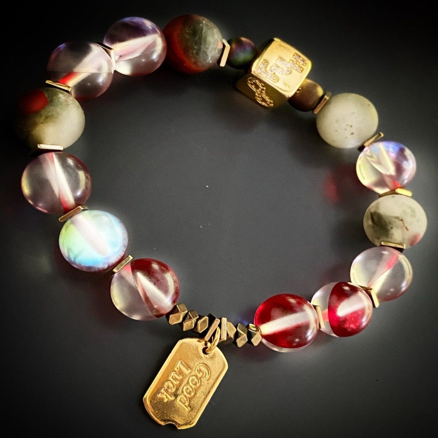 Immerse yourself in the vibrant energy of the Red &amp; Gold Good Luck Bracelet, adorned with red cat eye stone beads and gold spacers.