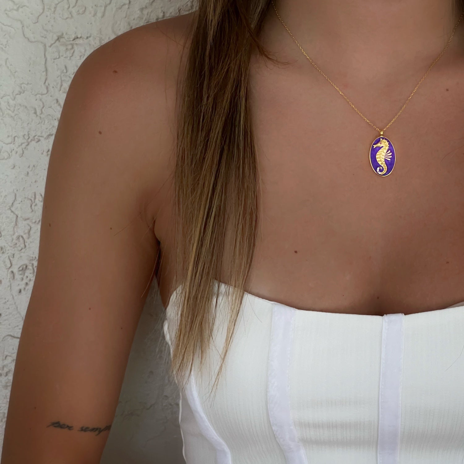 The Spirit Animal Blue Seahorse Necklace enhancing the neckline of a model, exuding a sense of protection and guidance.