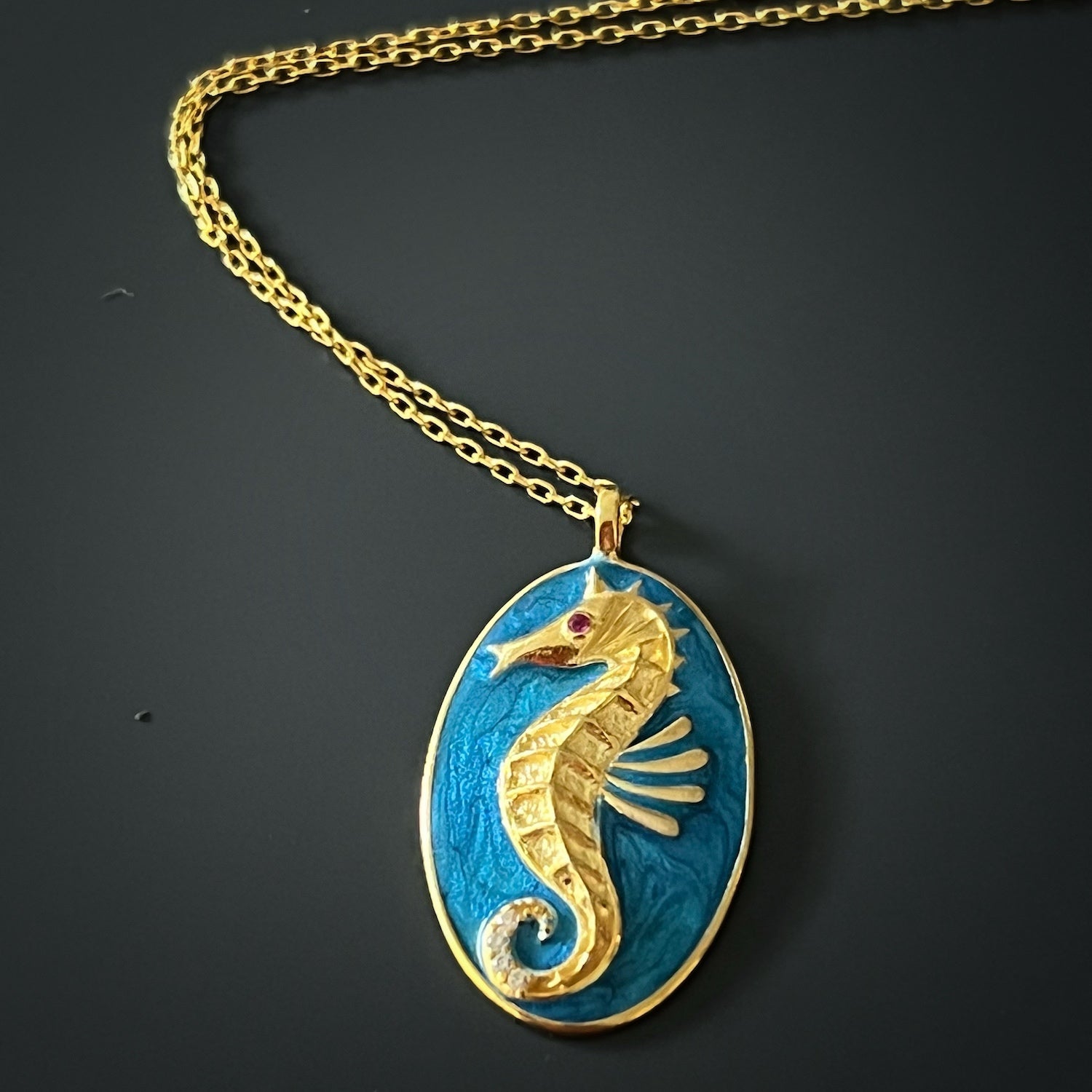A detailed shot of the Spirit Animal Blue Seahorse Necklace, highlighting the unique blue enamel design and the delicate features of the seahorse pendant.