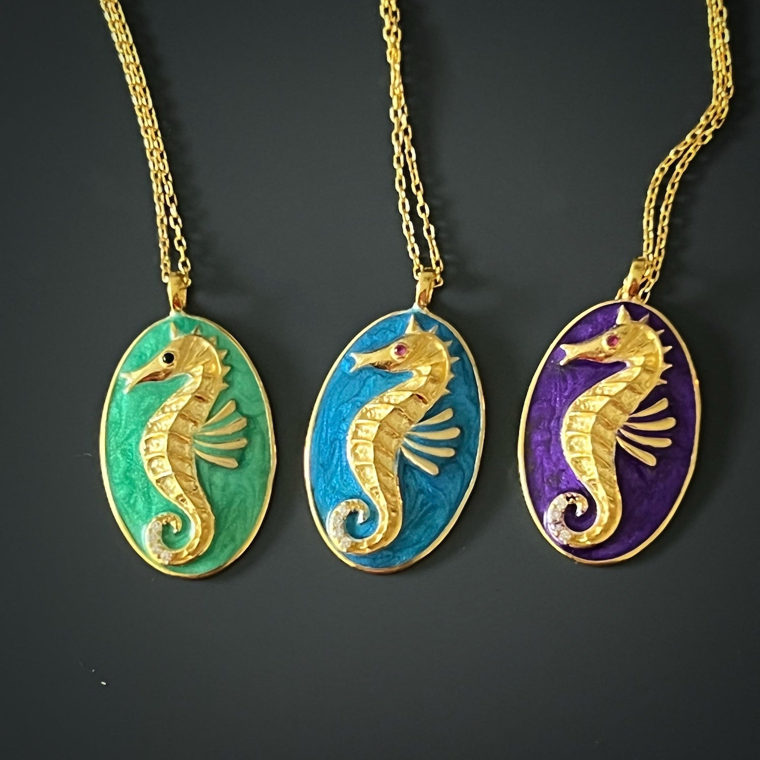 A detailed shot of the Spirit Animal Seahorse Necklace, highlighting the purple enamel accents and delicate features of the seahorse pendant.
