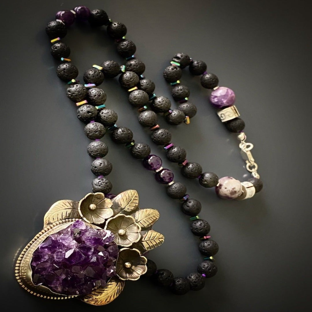 Handmade necklace featuring a captivating flower silver pendant with a row of healing amethyst stones.