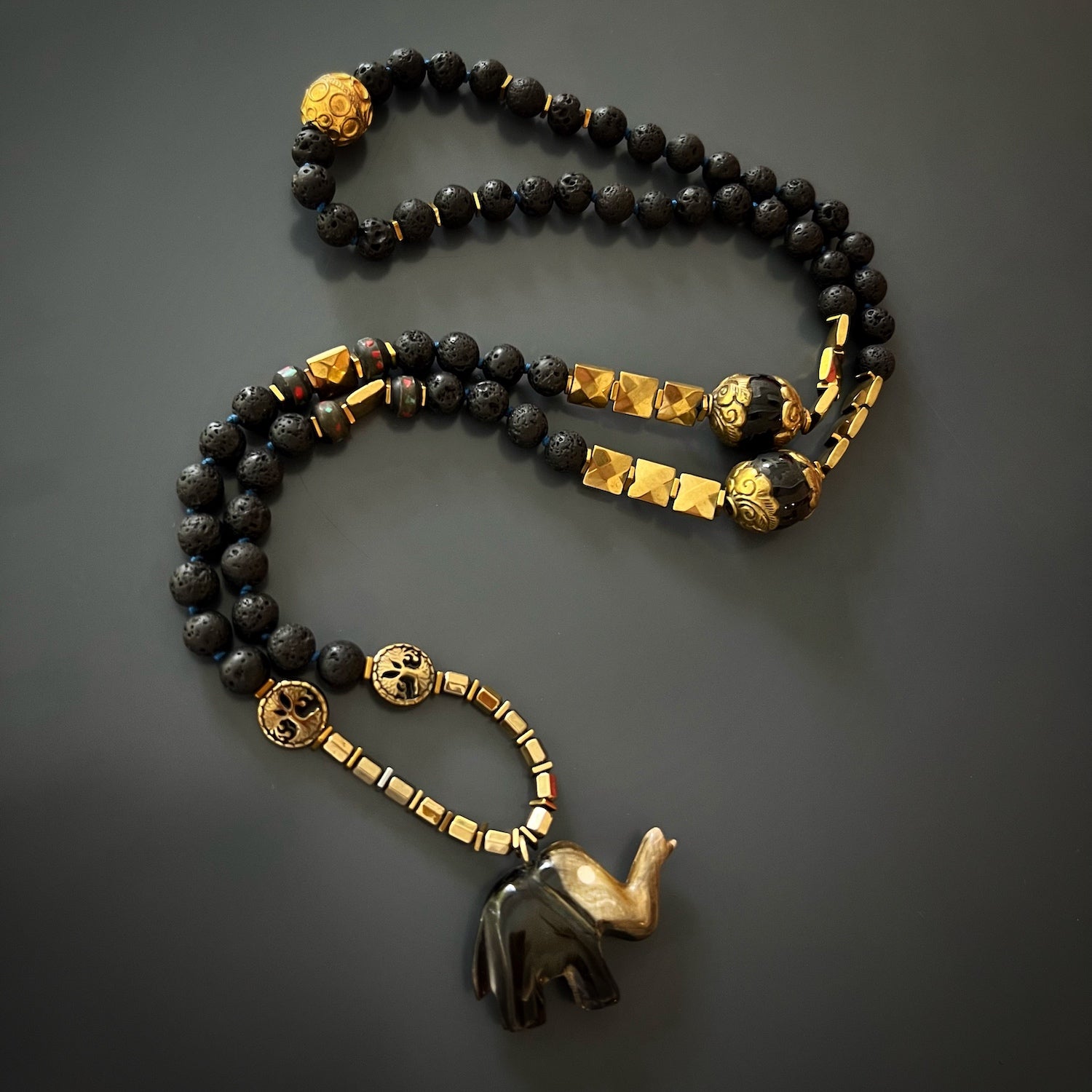 Experience the grounding energy of the Spiritual Nepal Elephant Necklace, featuring lava rock and hematite beads