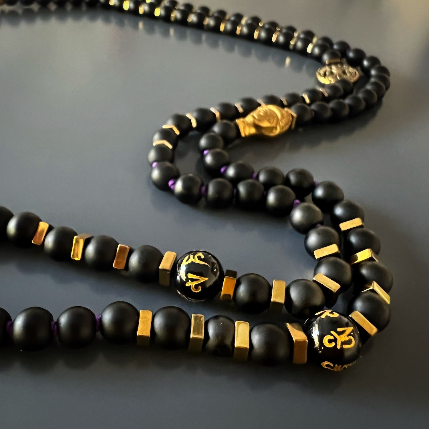 The powerful Om pendant, symbolizing the interconnectedness of all things, in the necklace