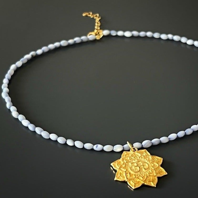 Necklace with a lotus and Om mantra pendant, perfect for a spiritual journey.