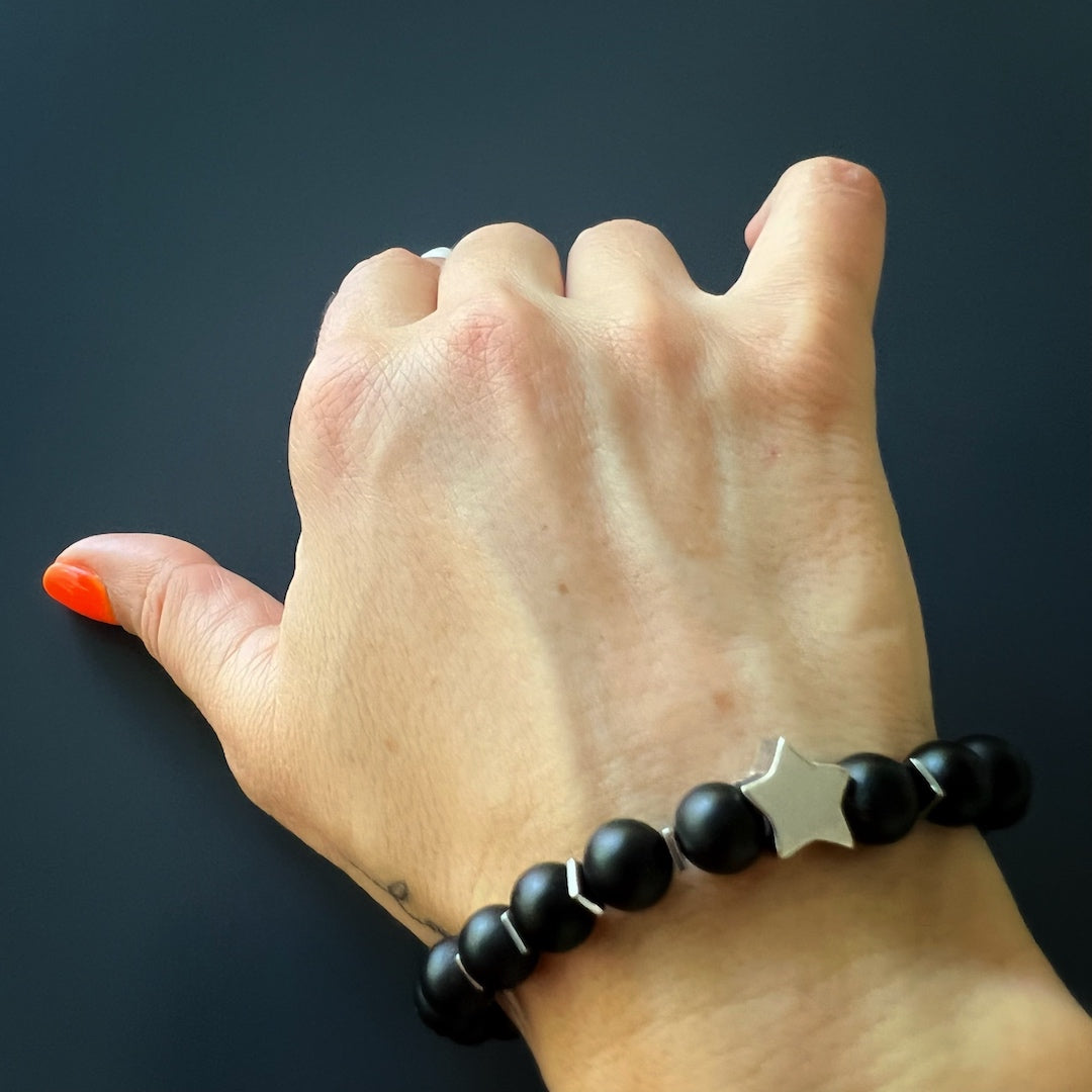 See the Sugar Skull Onyx Bracelet on the hand model's wrist, exuding edginess and style.