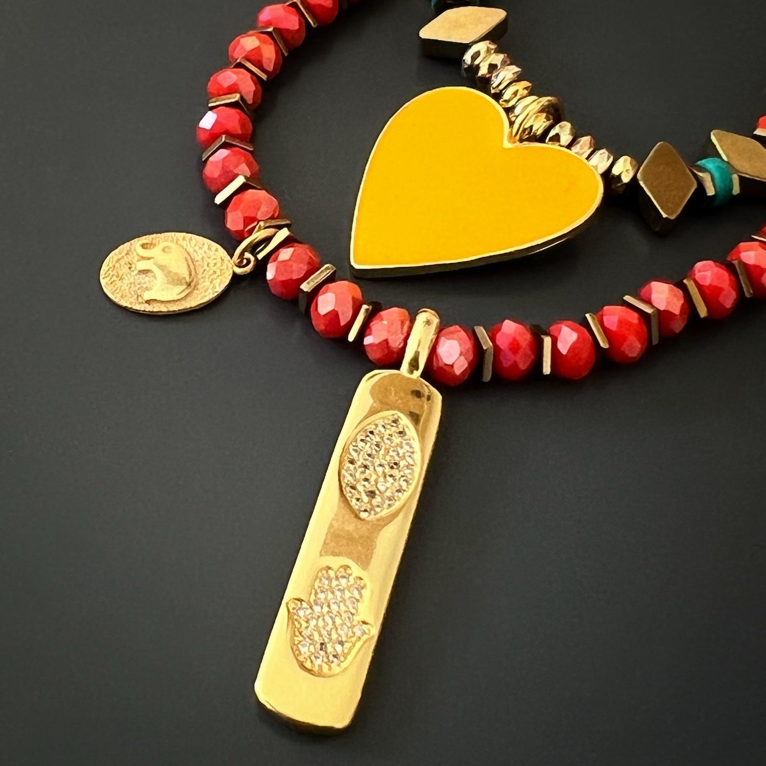 Spiritual and stylish necklace featuring an 18K gold plated Hamsa pendant and an elephant charm