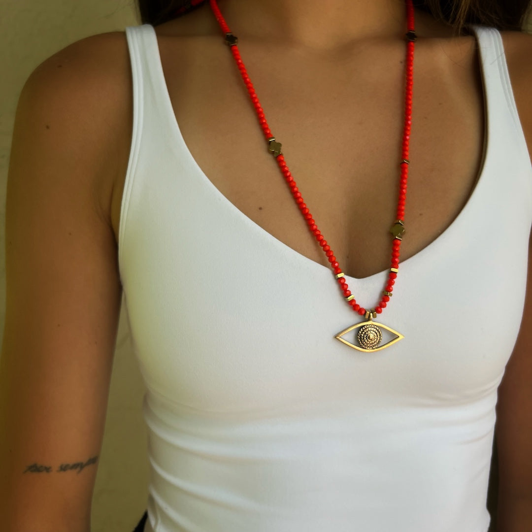 Stylish model showcasing the Handmade Necklace with red crystal beads and an Evil Eye pendant.
