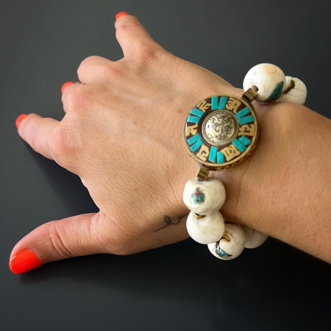 The hand model wears the Tibetan Mantra Bracelet, showcasing its spiritual significance and unique design.