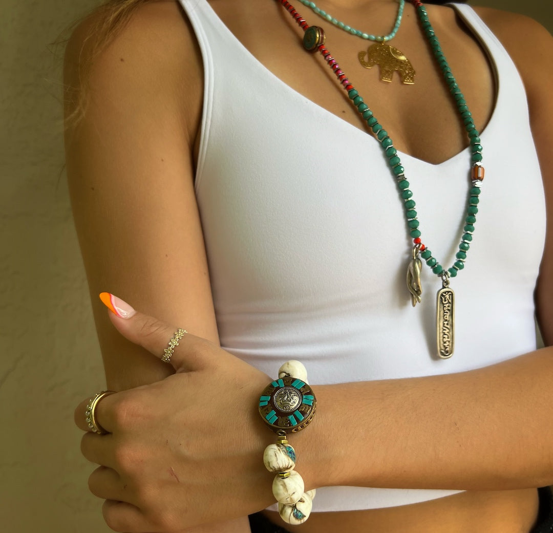 See the Tibetan Mantra Bracelet on the hand model's wrist, radiating positive energy and spiritual connection with the universe.
