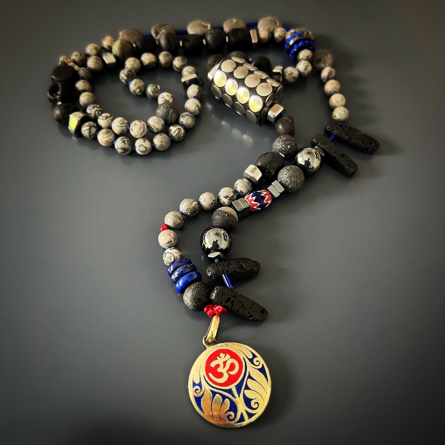 Adorn yourself with the Tibetan Om Necklace, a handmade masterpiece featuring a colorful blend of natural stones and a sacred OM pendant.