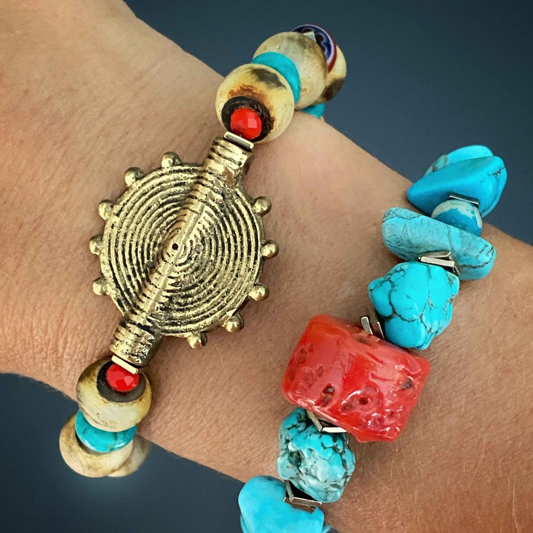 The model displays the Tibetan Ethnic Bracelet, highlighting its intricate craftsmanship and striking turquoise stone.