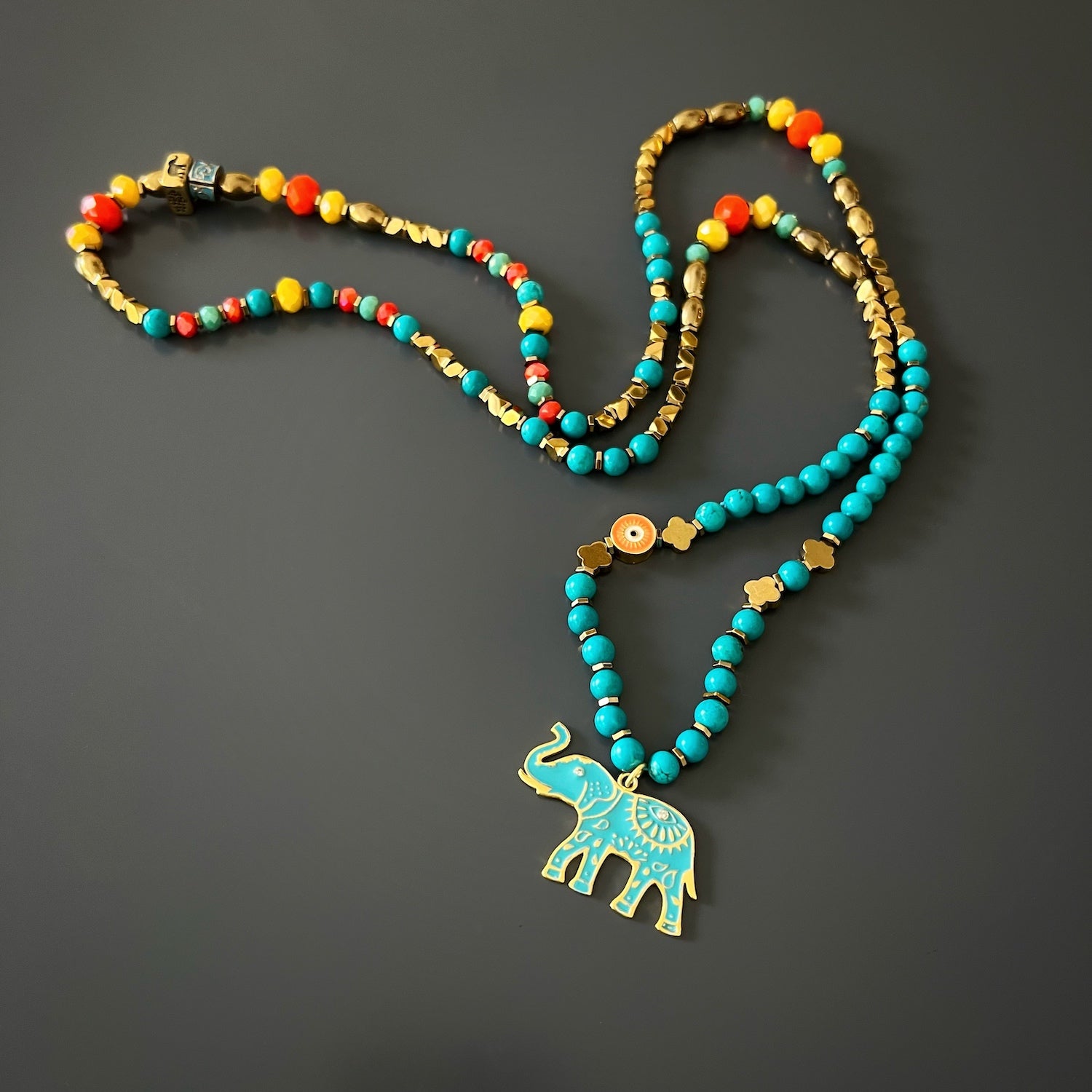 The Turquoise Blue Elephant Necklace, highlighting its unique combination of beads and symbols
