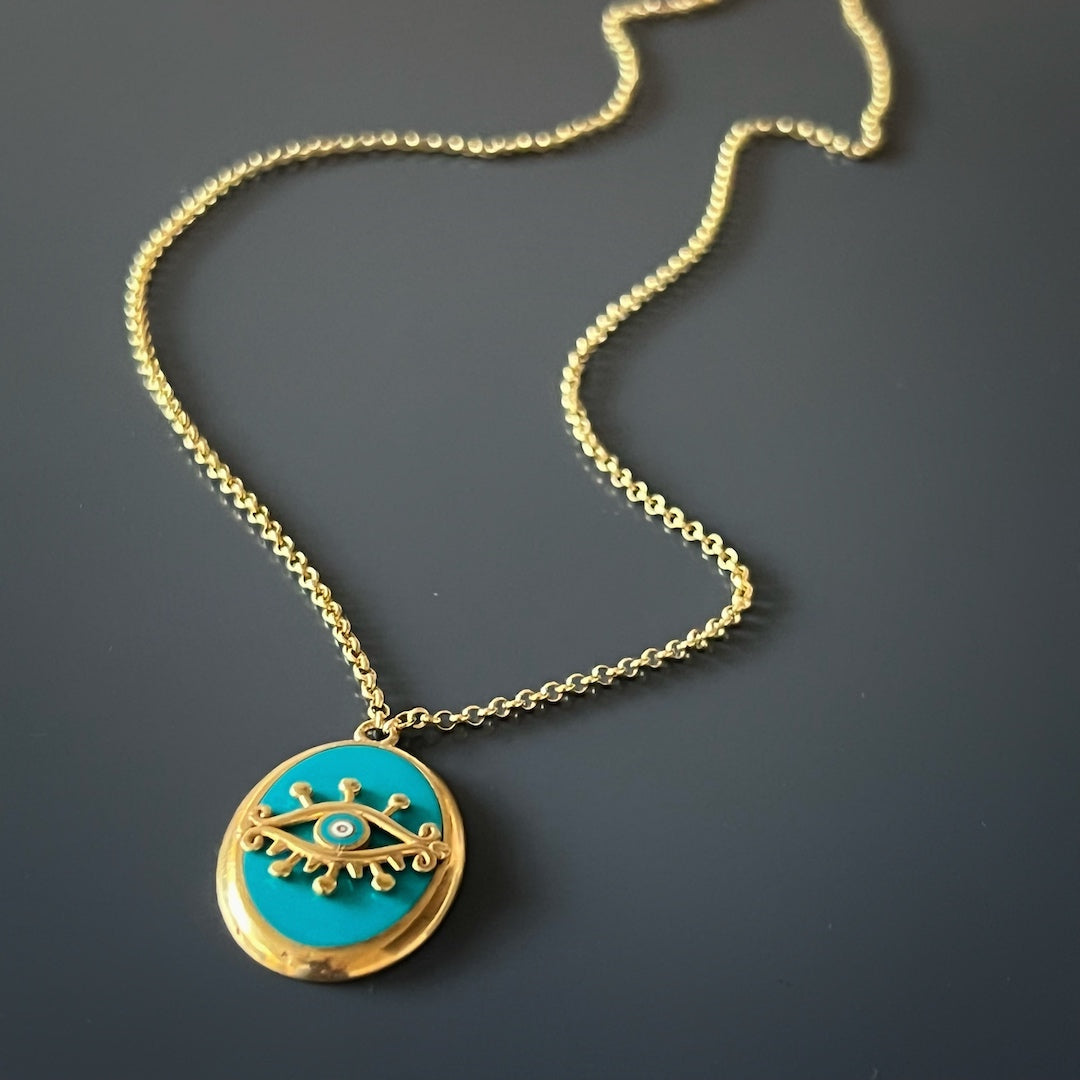 Elevate your look with the Turquoise Gold Evil Eye Necklace, a dainty and meaningful accessory for spiritual protection.