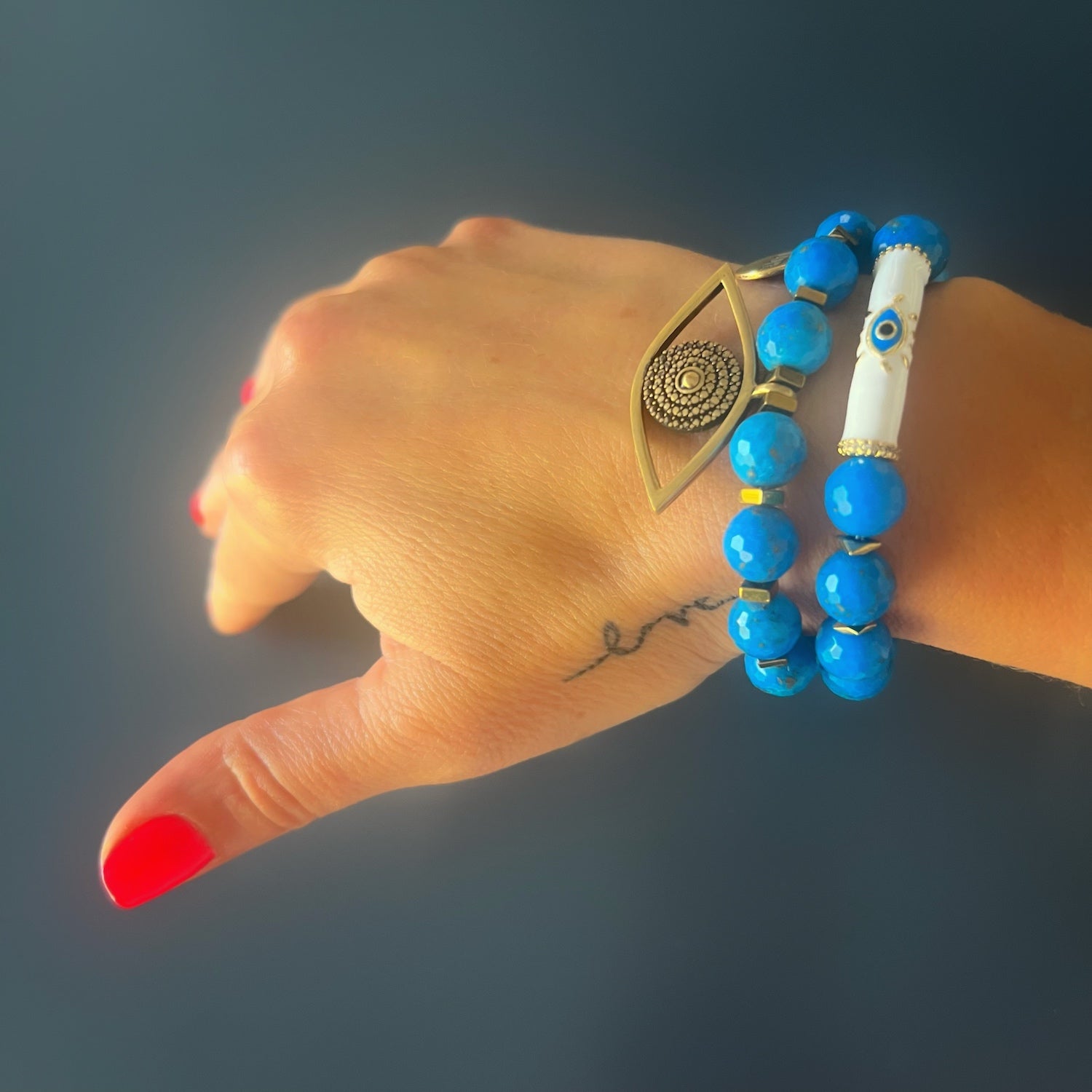 See how the Turquoise Inner Calm Bracelet beautifully adorns the hand model&#39;s wrist, radiating a sense of tranquility and sophistication.