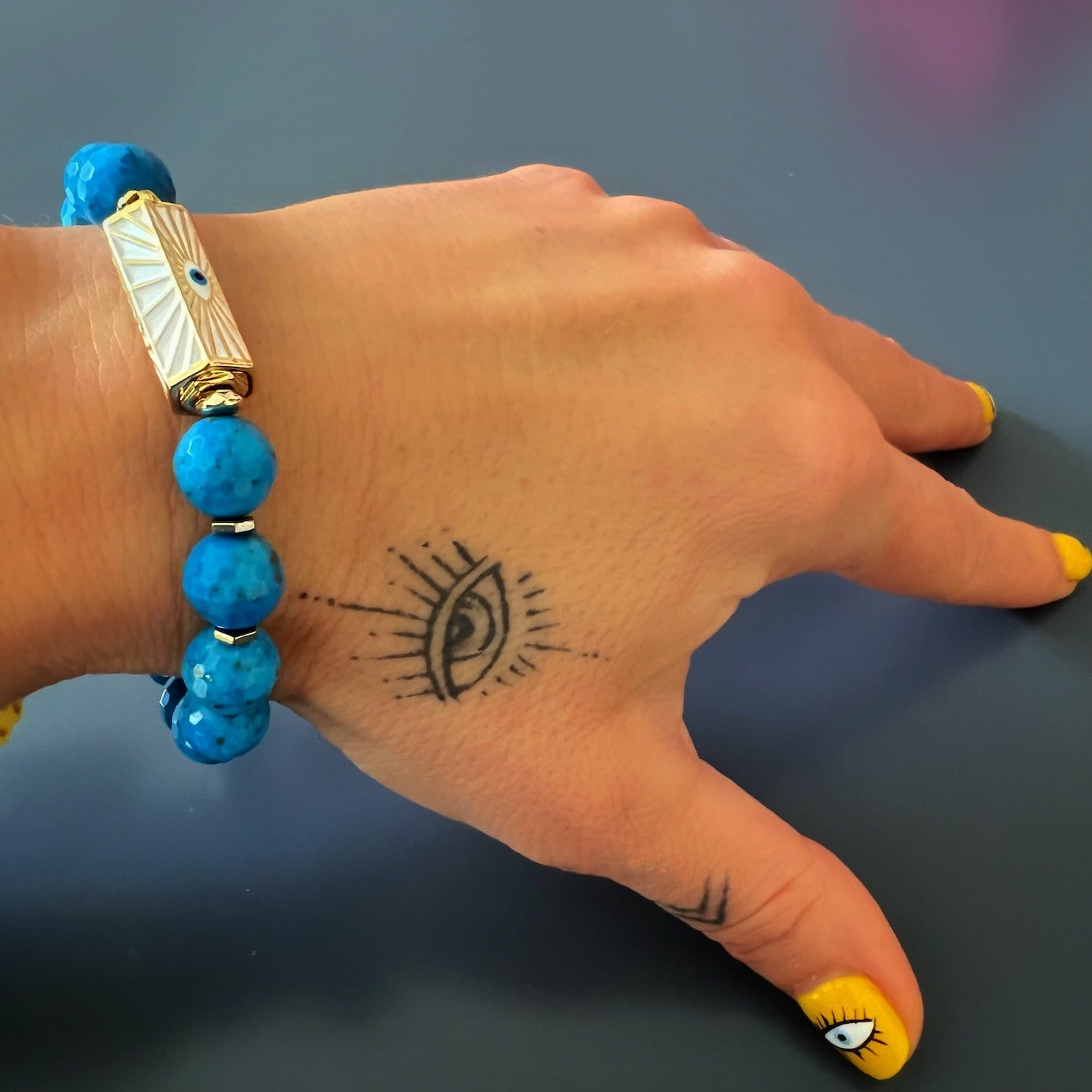 The hand model showcases the elegance and symbolism of the Turquoise Luck and Protection Bracelet, radiating positive energy.