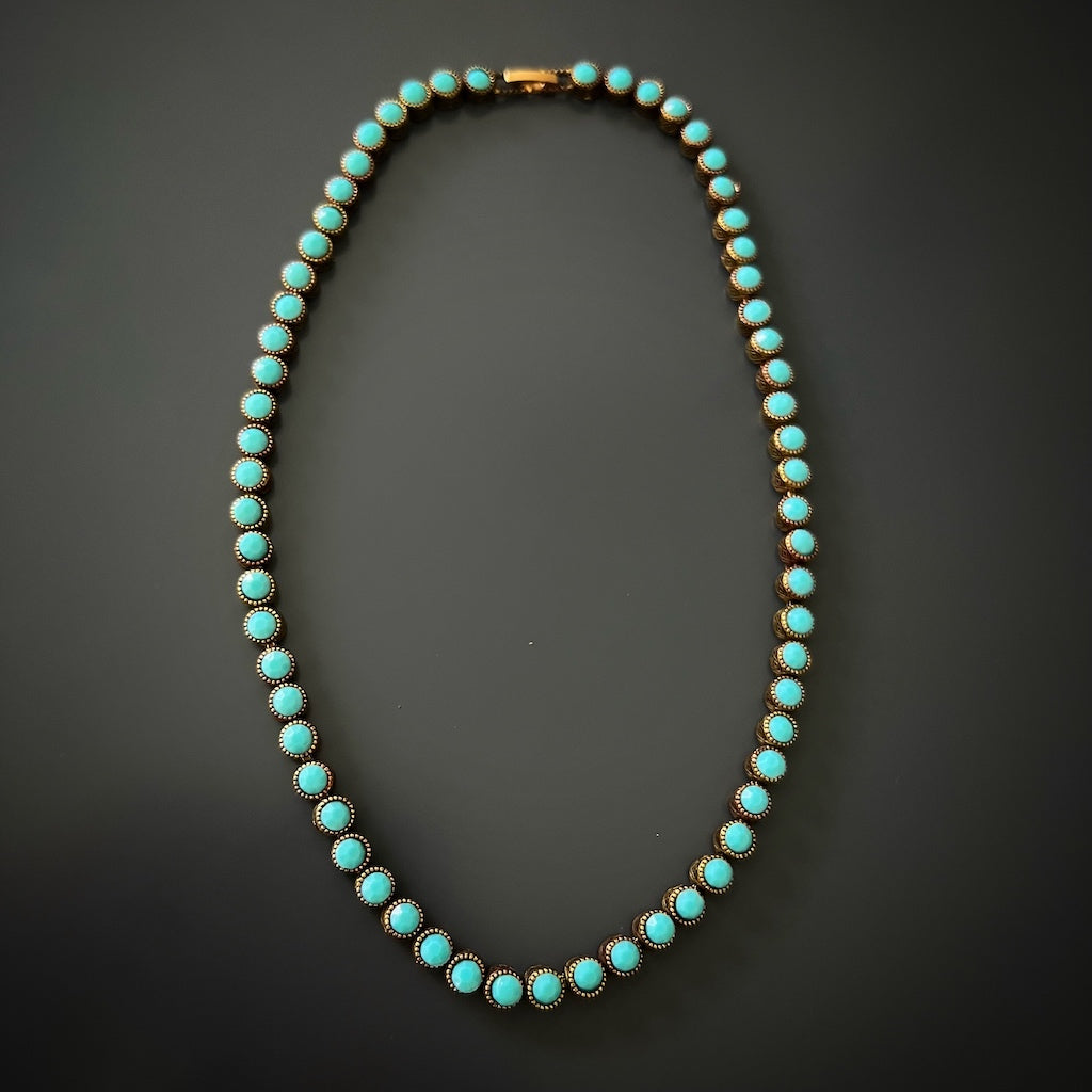 The soothing energy of turquoise radiates from this handmade bronze necklace, offering a sense of balance and calmness.