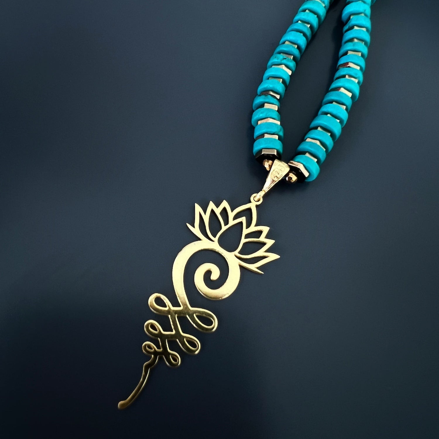 The gold hematite spacers adding a touch of elegance to the Turquoise Unalome Serenity Necklace