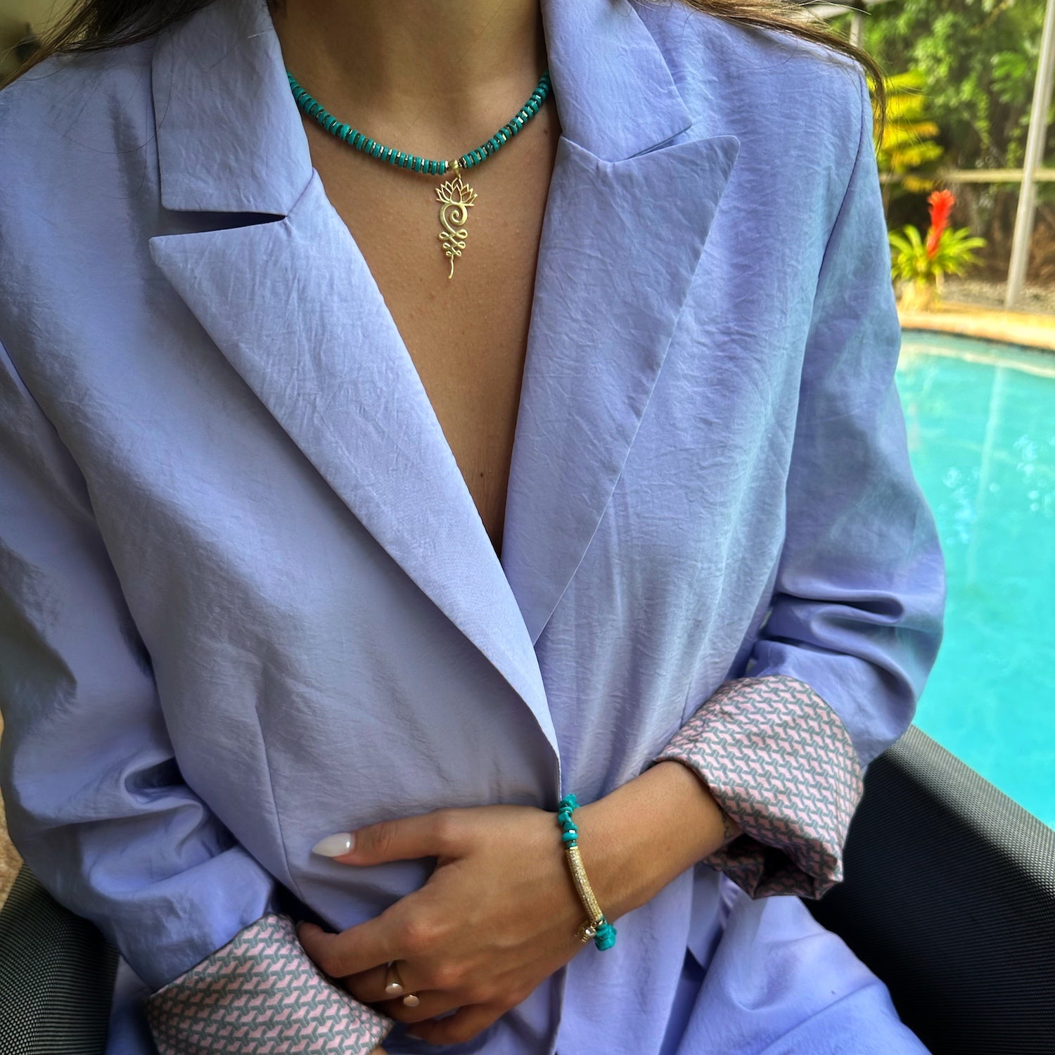 A model gracefully wearing the Turquoise Unalome Serenity Necklace, embodying serenity