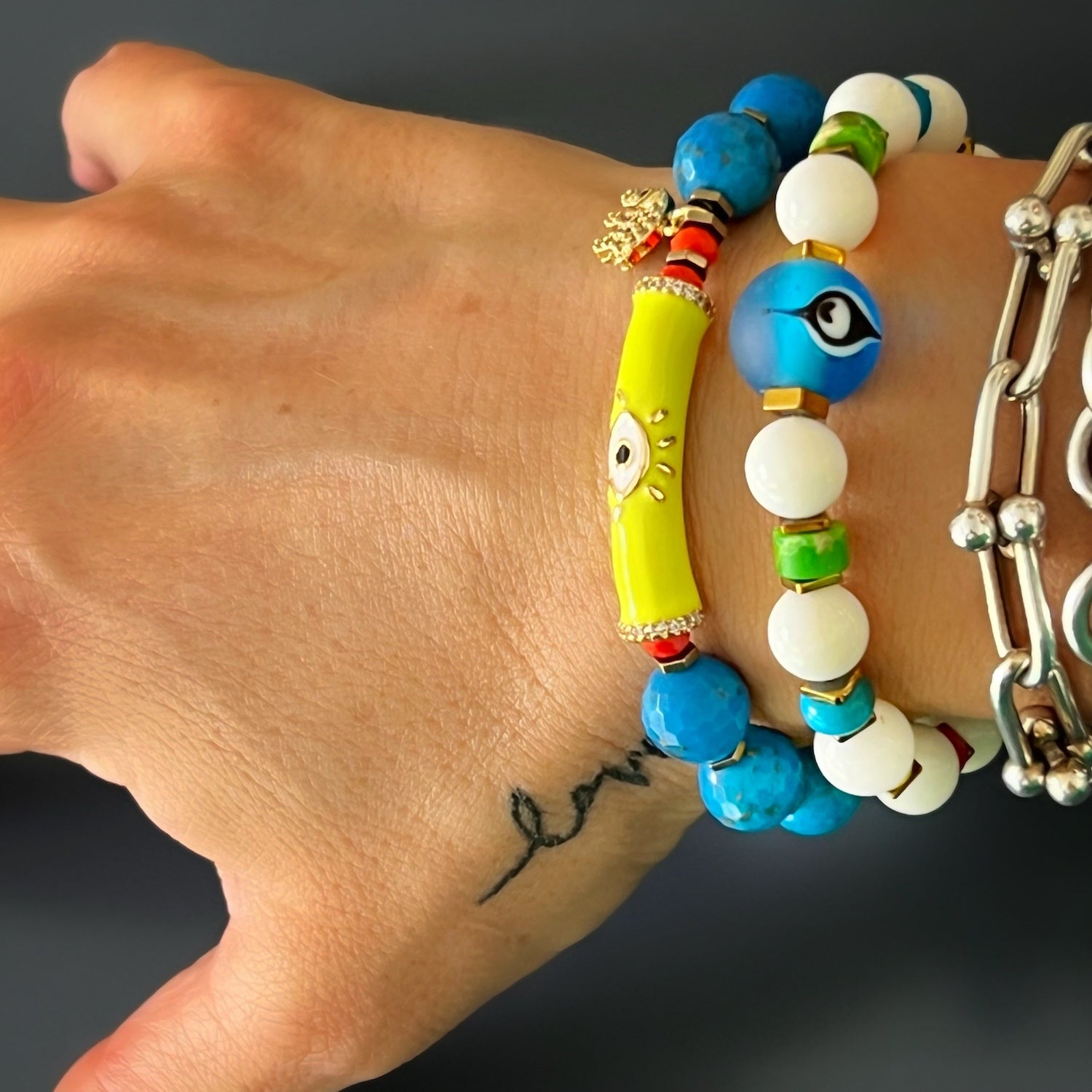 The hand model wears the Turquoise Unique Protection Bracelet, demonstrating its elegance and powerful symbolism.