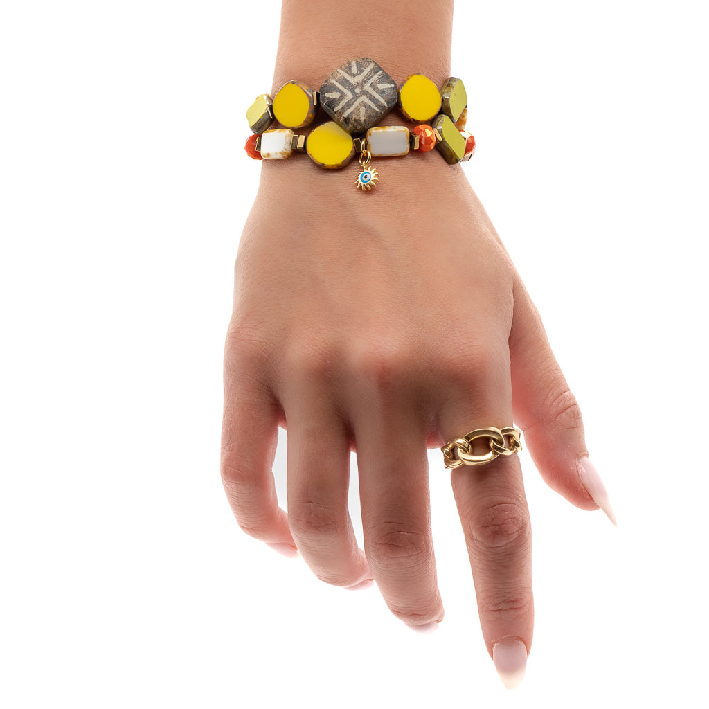 Experience the beauty of the Unique African Bracelet Set as it adorns the hand model's wrist, adding a unique and playful element to her look.