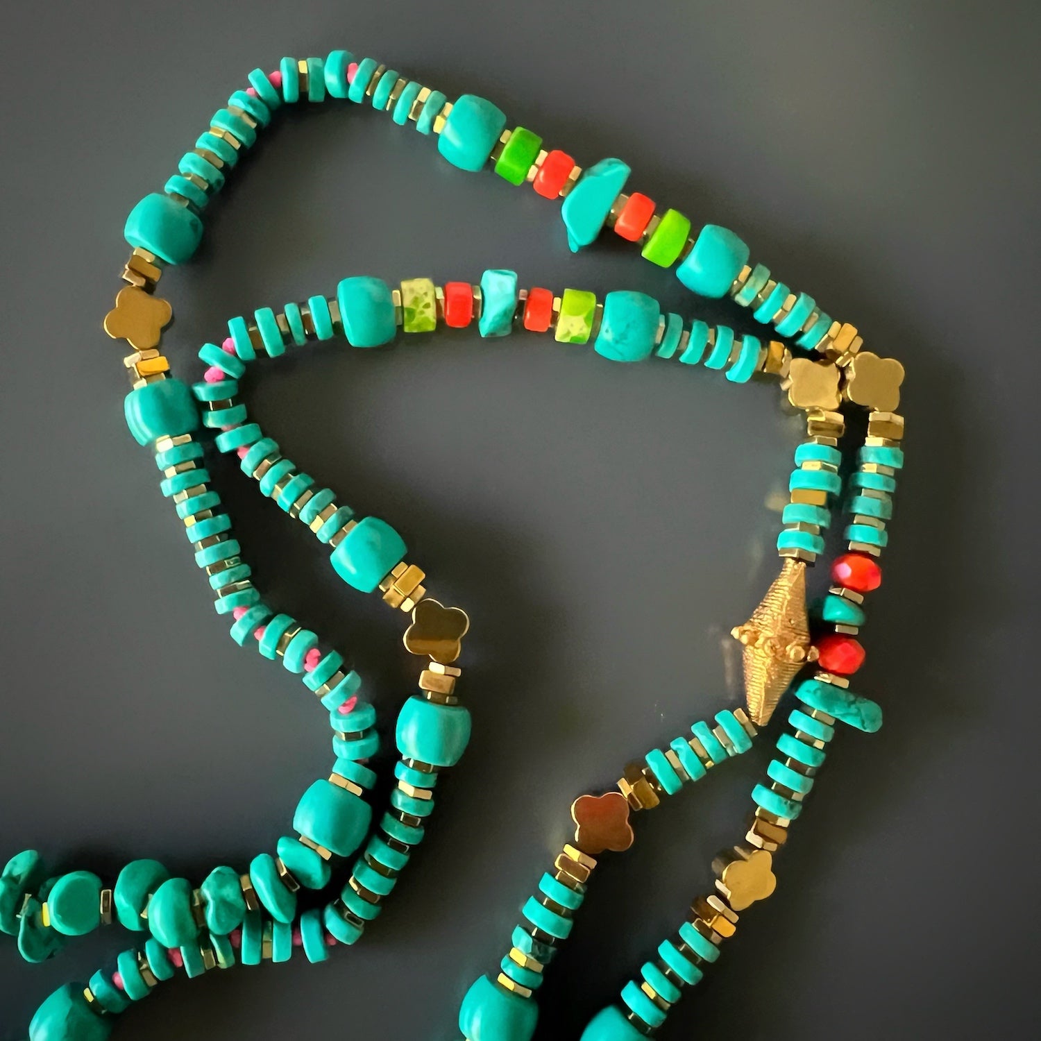 The turquoise and hematite beads representing spiritual and protective elements on the necklace