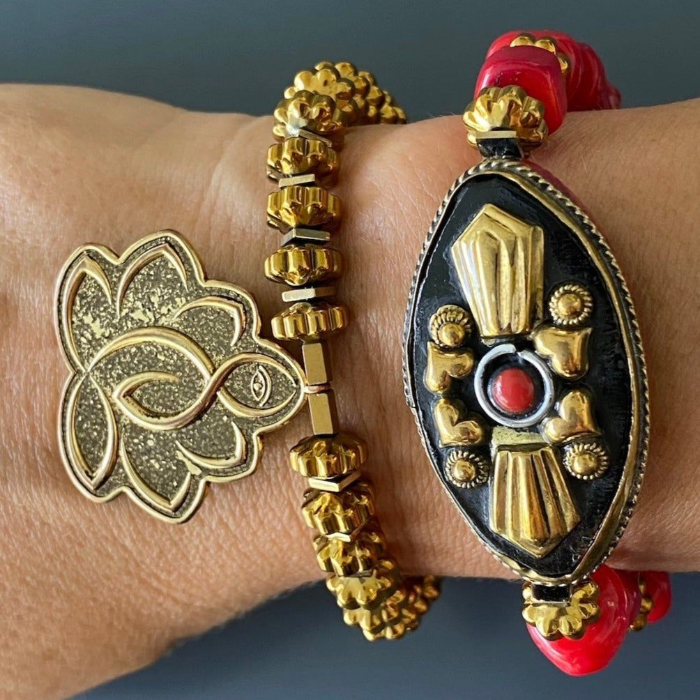 Hand model showcases the intricate design and vibrant colors of the Vintage Style Ethnic Om Bracelet, embracing its cultural charm.