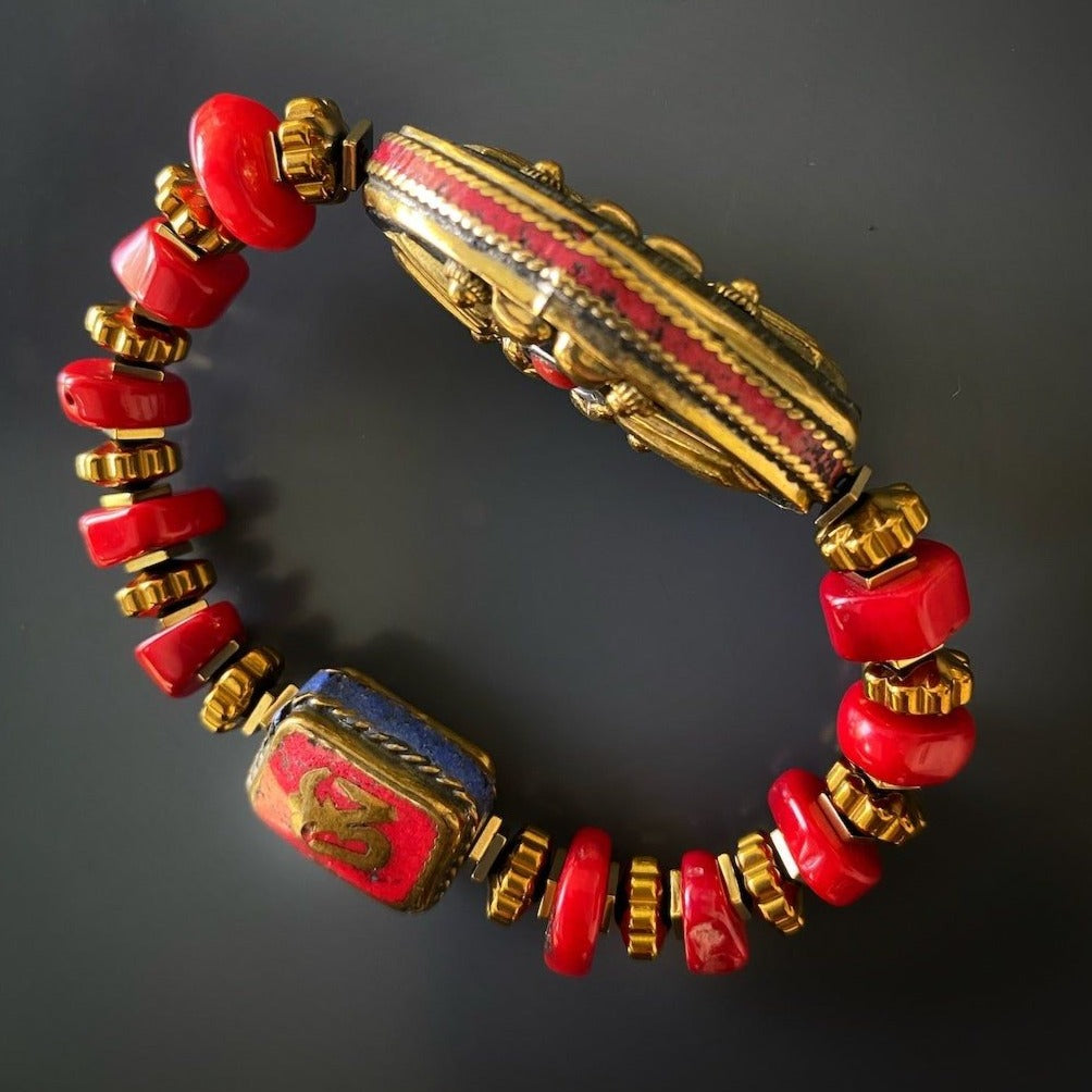 Admire the craftsmanship of the Vintage Style Ethnic Om Bracelet, a unique piece with red coral beads and a Nepalese charm.