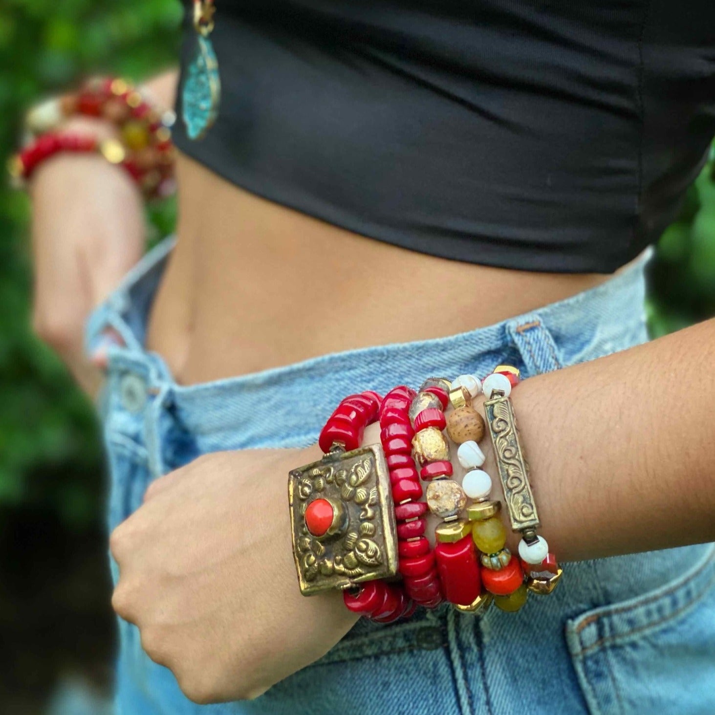 The model showcases the Vintage Style Tibetan Bracelet Set, highlighting its intricate designs and vibrant colors.