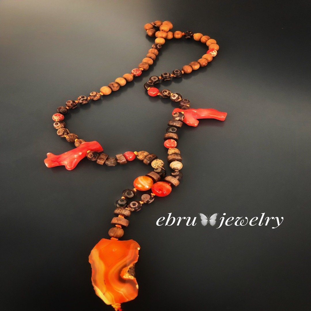 the Healing Agate Necklace highlighting the orange coral spacer stones and the 10mm agate beads that complement the pendant.
