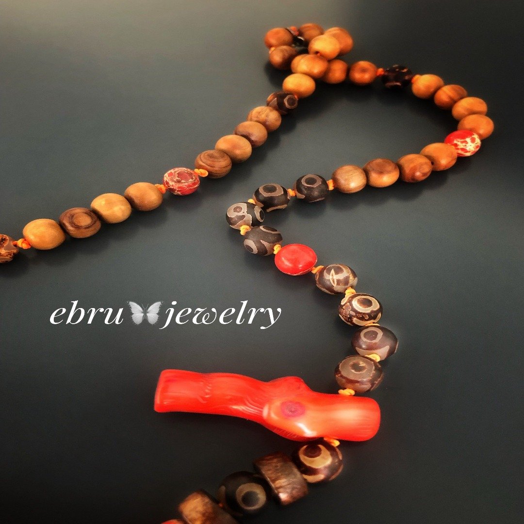 the Healing Agate Necklace displaying the unique boho-inspired design and the natural elements like wooden beads and sandalwood beads.