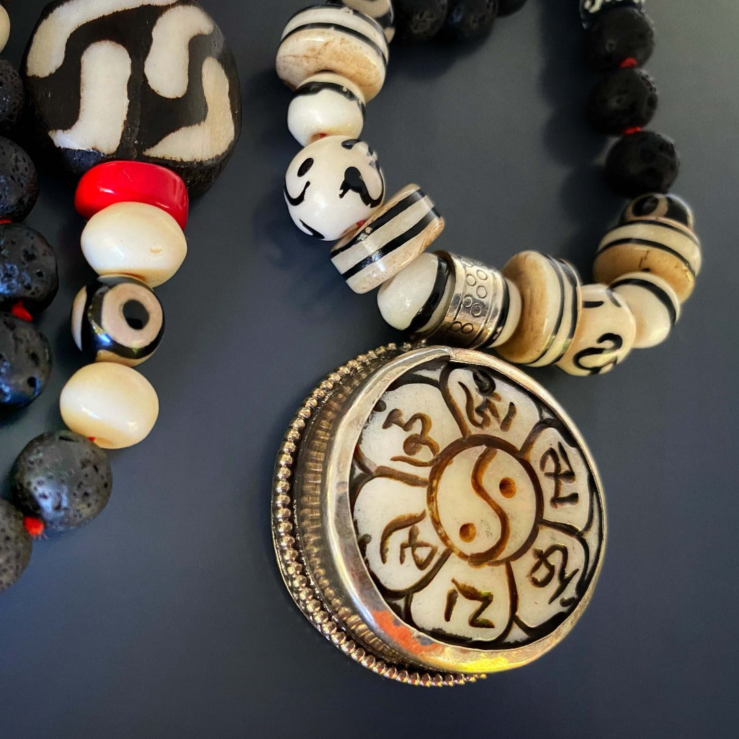 Necklace adorned with black lava rock and Nepal bone beads, centered around a beautifully crafted Yin Yang pendant.