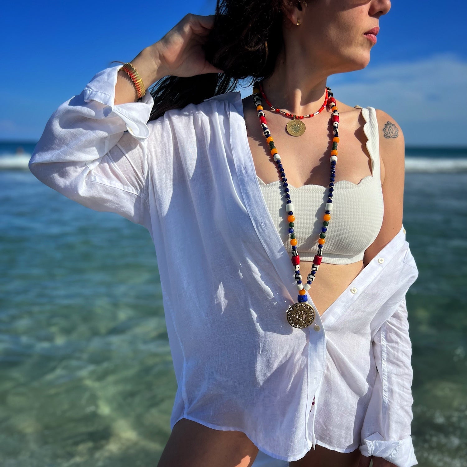 The model radiates tranquility while wearing the Yoga Necklace, showcasing its spiritual essence and elegance.