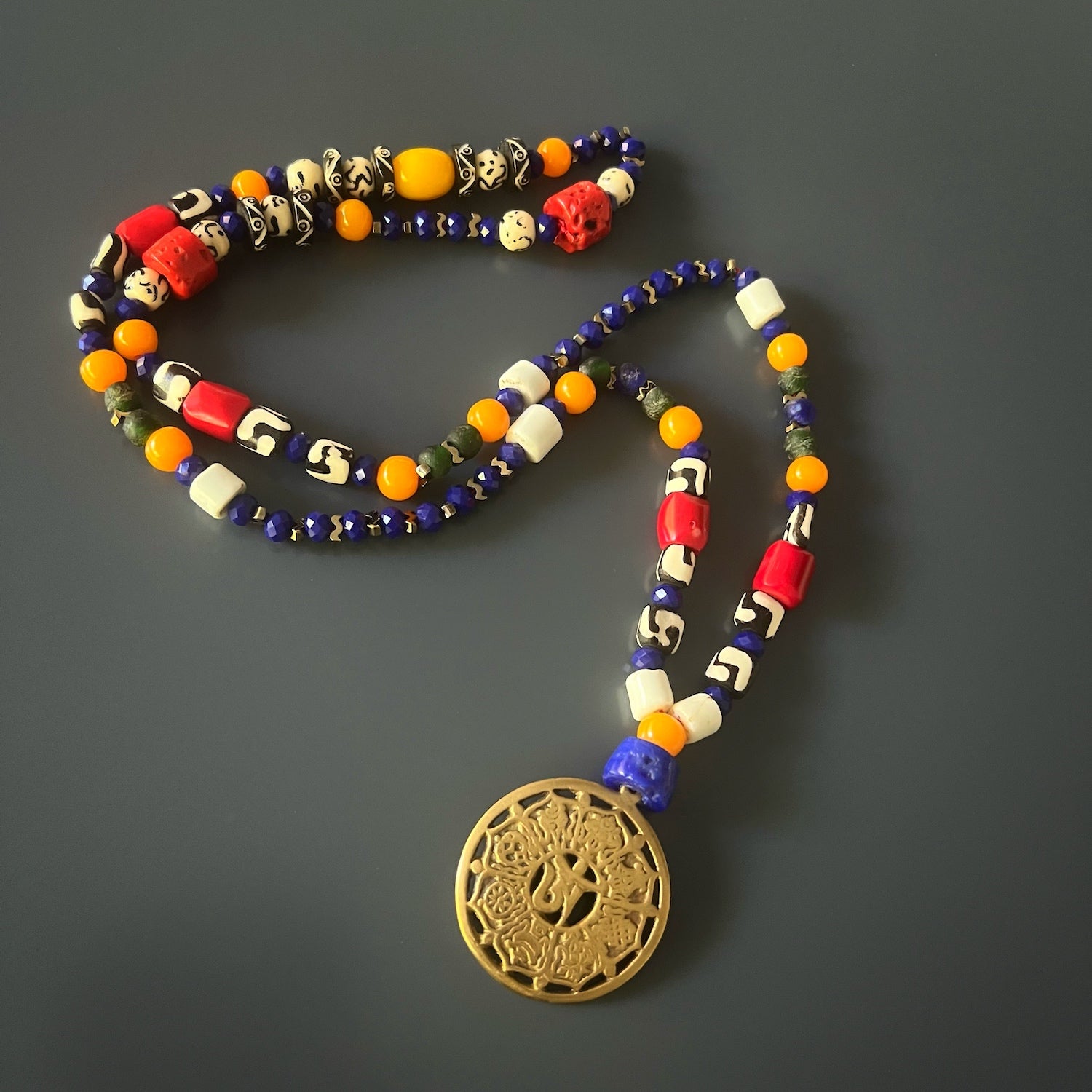 Embrace the spiritual journey with the Yoga Necklace, featuring a beautiful OM pendant and carefully selected beads.