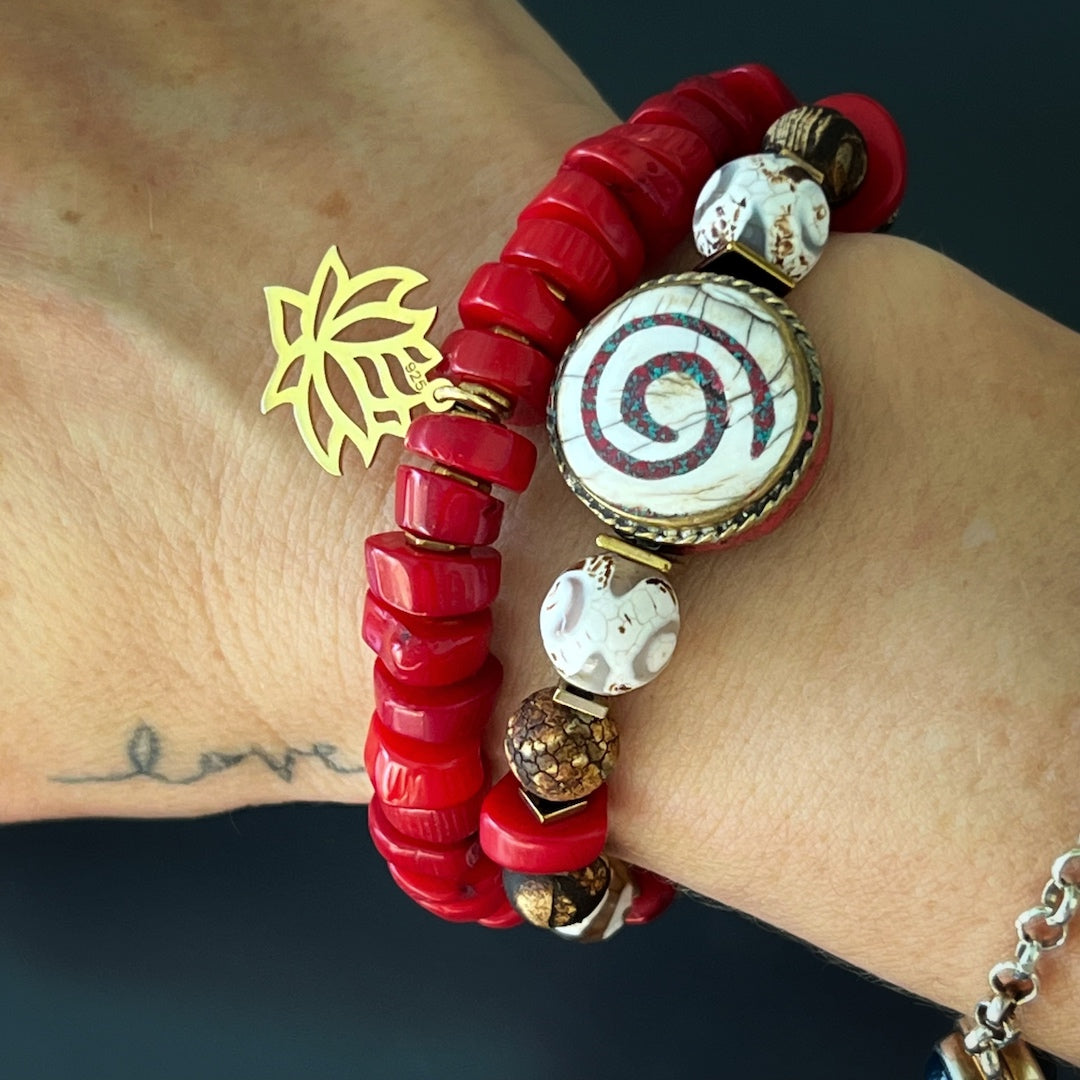 See how the Yoga Spirit Mystic Bracelet adorns the hand model's wrist with its coral stone beads, Nepal meditation beads, and the vibrant energy it brings.