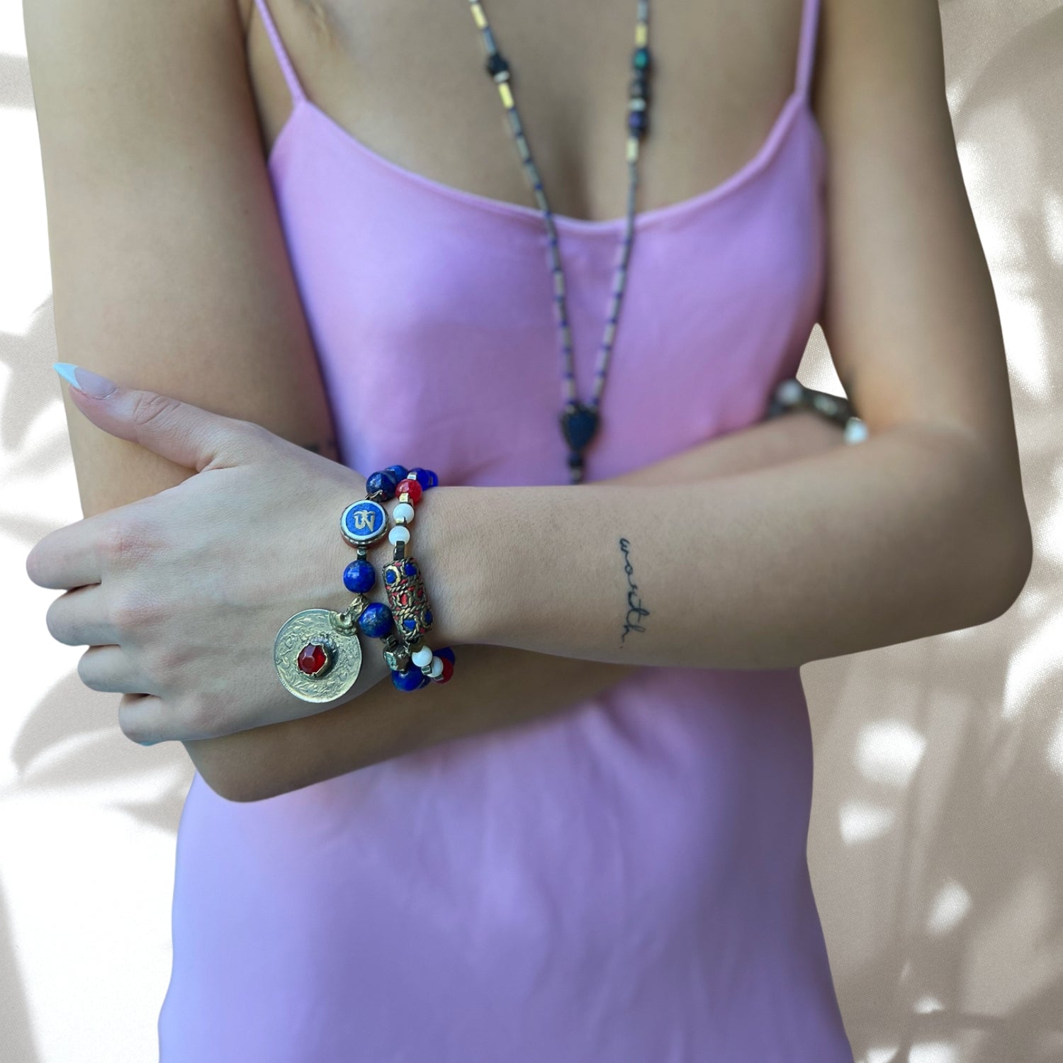 Unique Aegean Bracelet Set with Lapis Lazuli Nepal Om Bead, handcrafted and one of a kind, shown by model