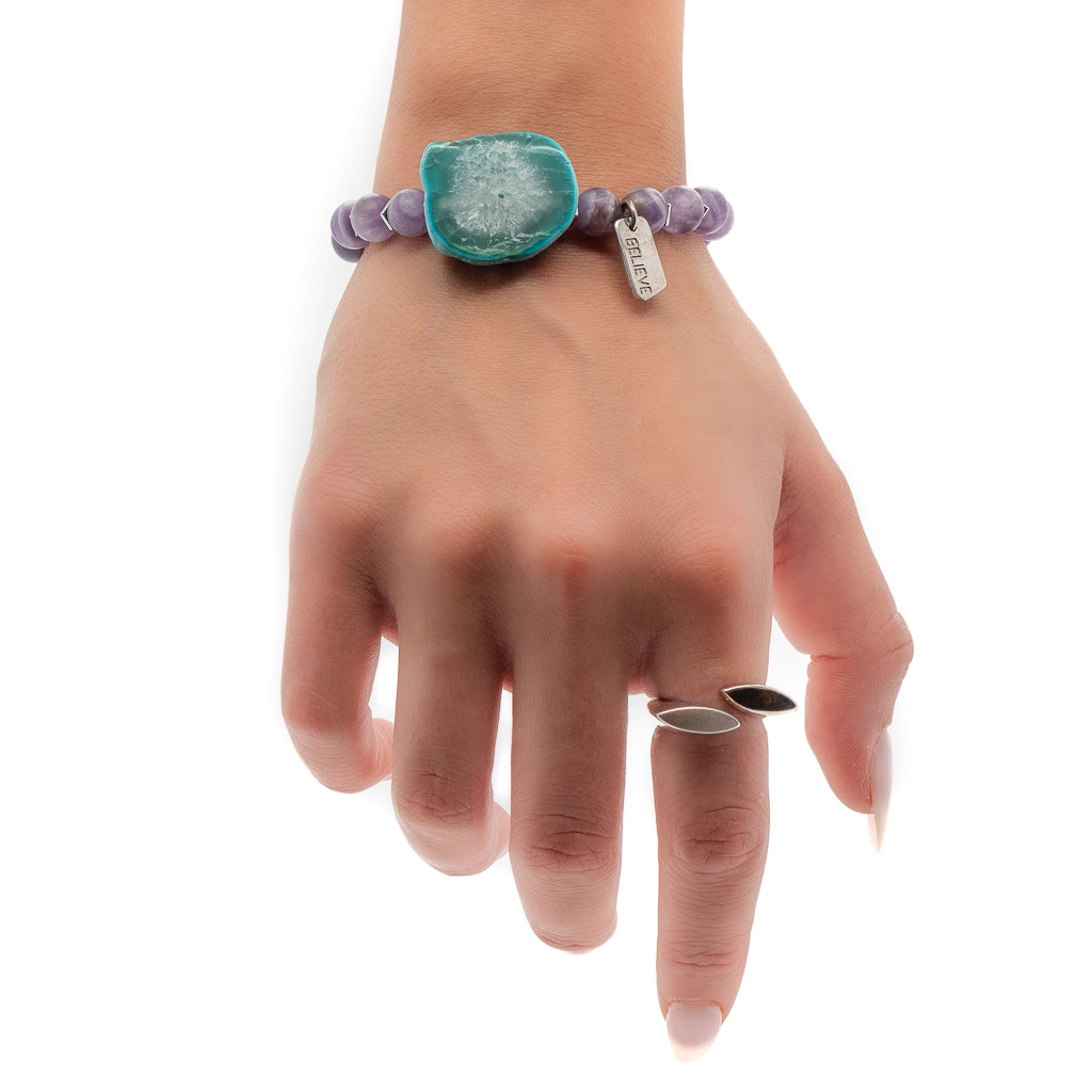 Hand model wearing the elegant Believe in Magic Bracelet with a silver believe charm and large aqua Amazonite natural stone.