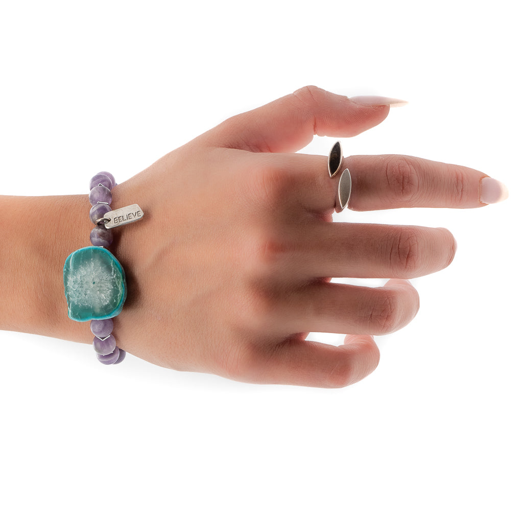 Hand model wearing Believe in Magic Bracelet with violet amethyst and aqua Amazonite natural stone.