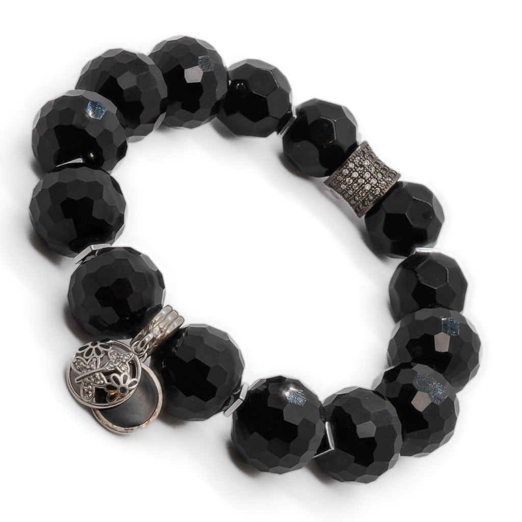 A closer look at the Black Protection Bracelet highlighting the intricate silver butterfly charm
